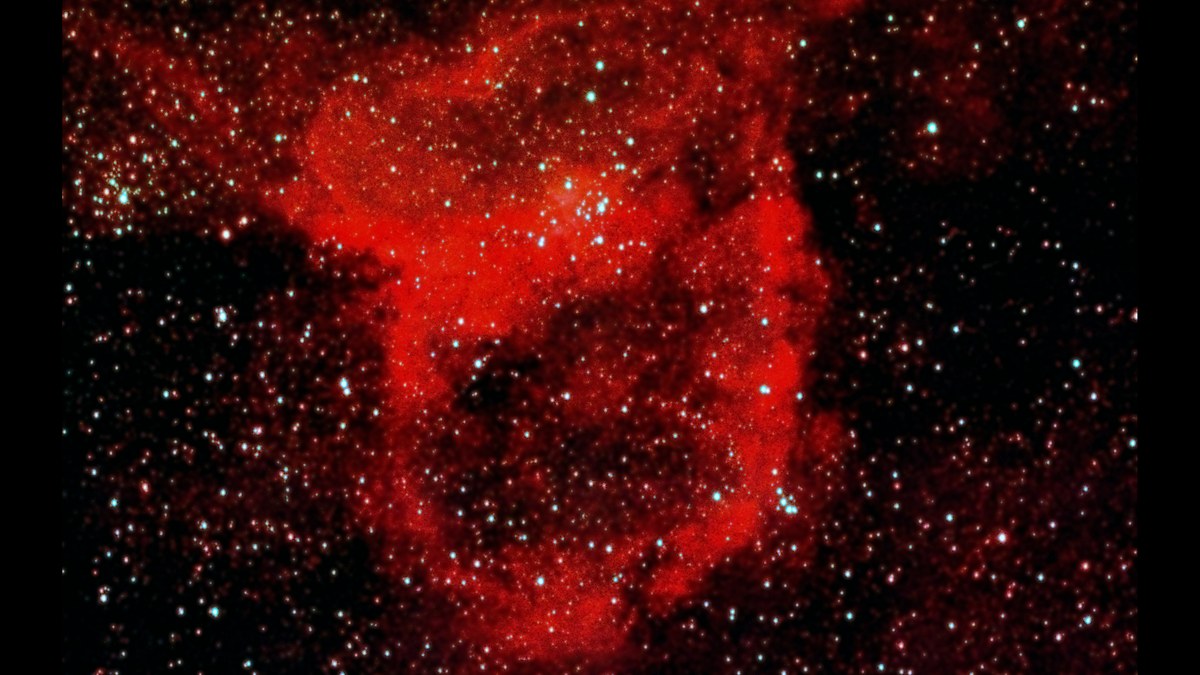 IC 1805, the Heart Nebula, a large red heart shaped cloud with a cluster of blue white stars inside it, and the smaller Fishhead Nebula above it to the right.