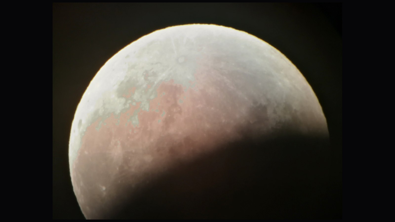 The Moon during the partial lunar eclipse of 16 July 2019, the Earth’s shadow lying as a soft dark curve across the lower part of the disc.