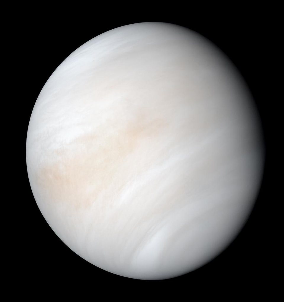 Venus photographed by the Mariner 10 spacecraft, a featureless cream coloured globe wrapped in unbroken cloud.